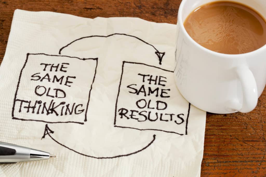 3 Mindset Shifts for Teachers - this is an Image of a napkin with a coffee cup. On the napkin is drawn a cause and effect flow chart - The same old thinking >> The same old results (and vise-versa)